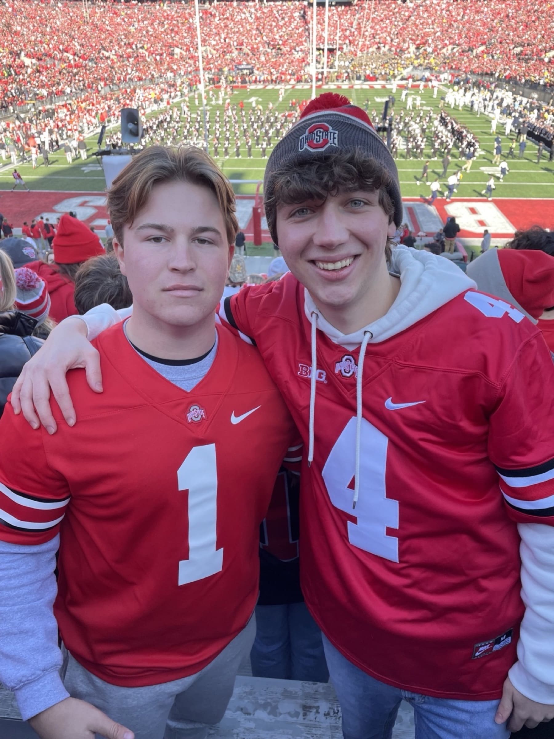 Alec Levine and a friend at Ohio Stadium with the marching band on the field