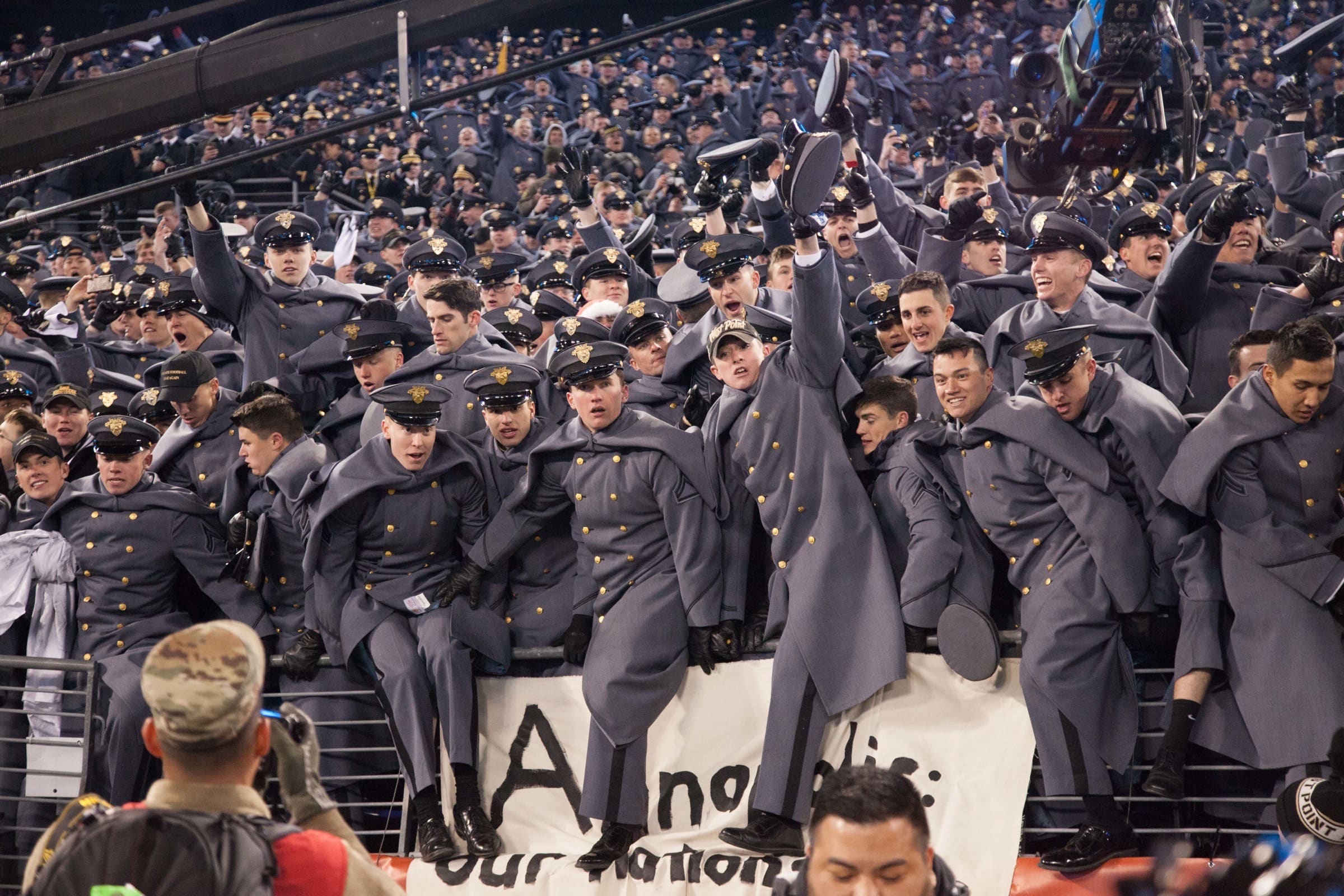 Army cadets celebrating together in the stands after the Army–Navy game